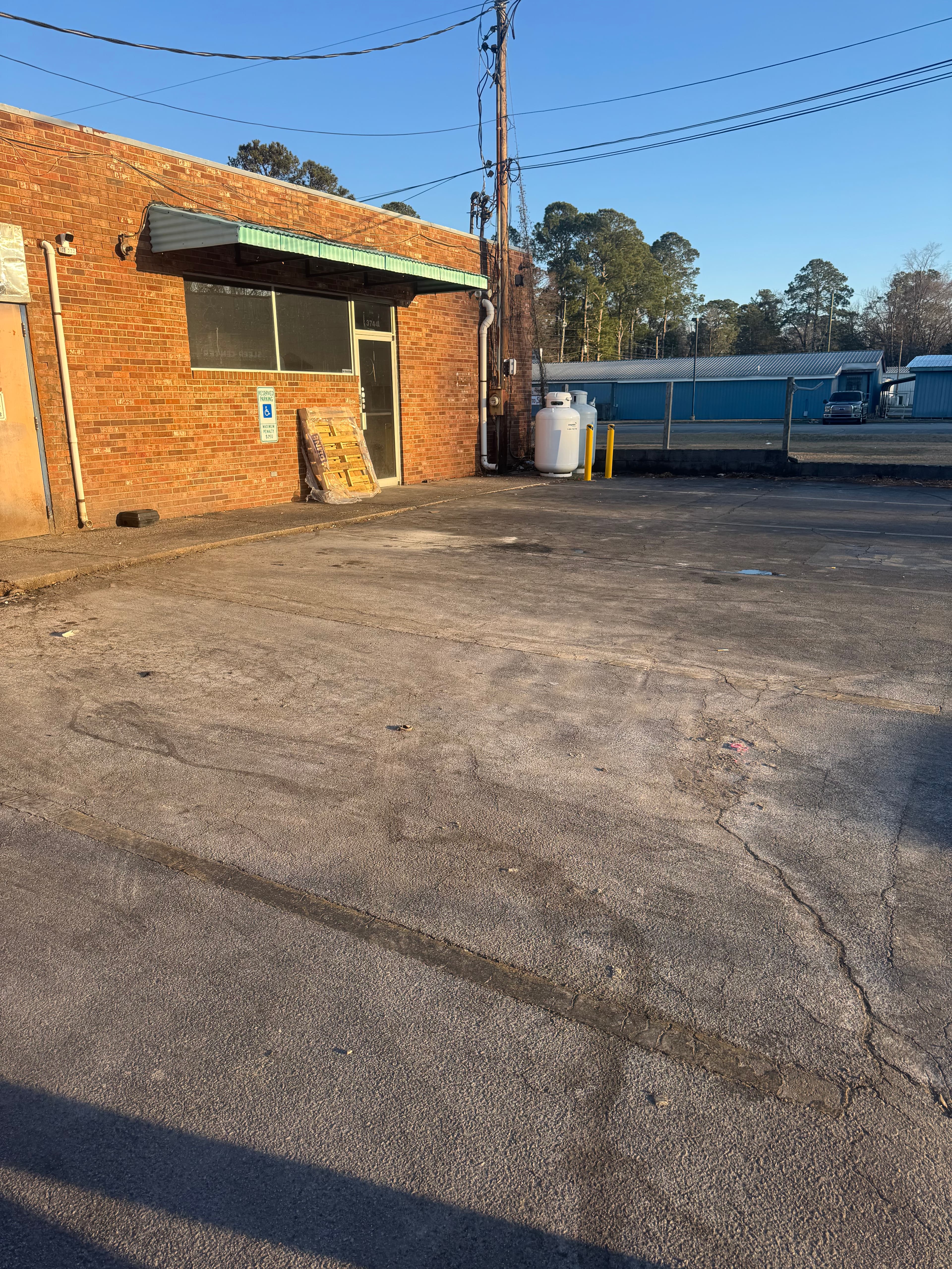 Commercial parking lot with heavy grime and staining in Fayetteville NC