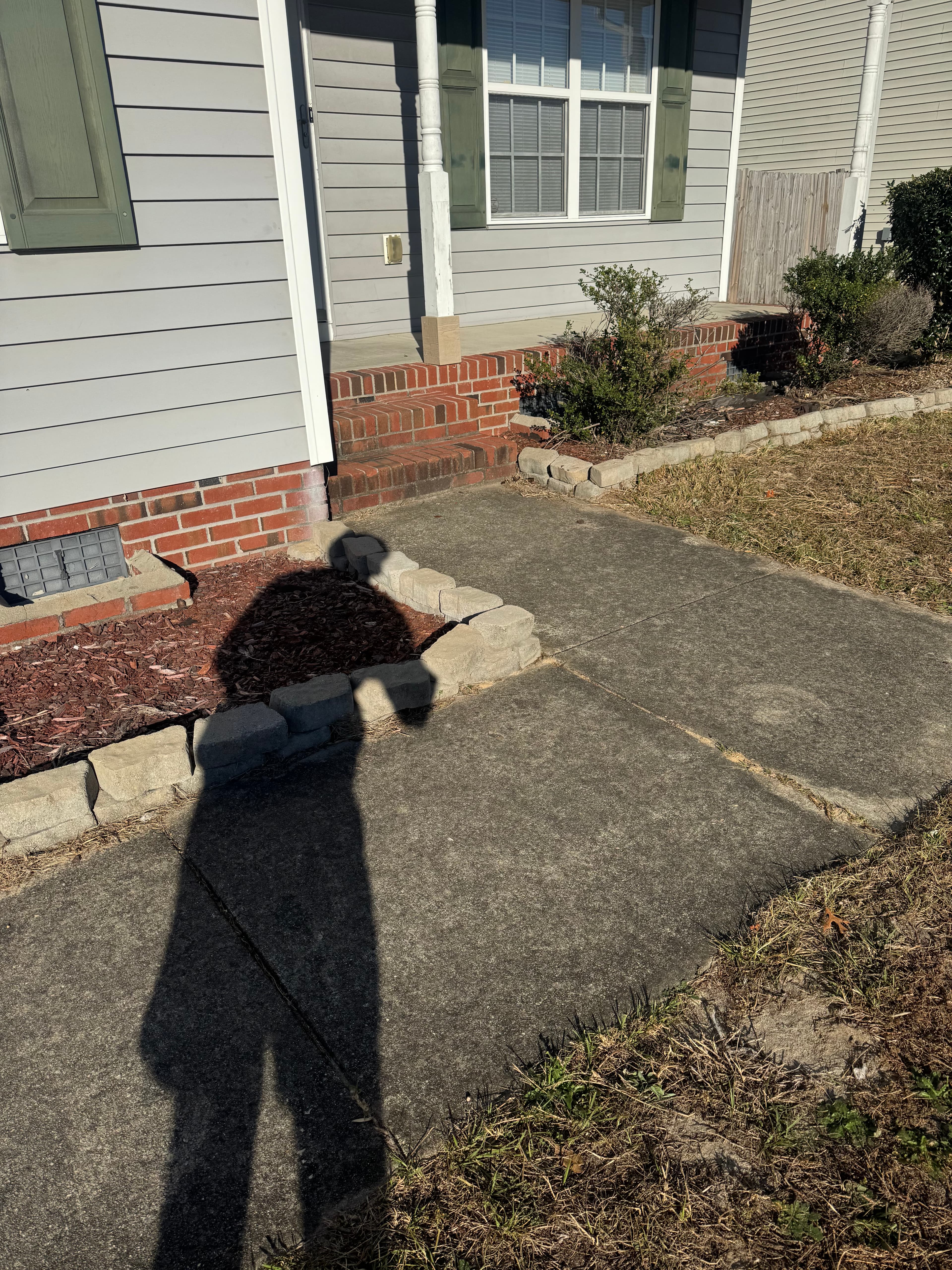Concrete sidewalk with years of grime and buildup in Fayetteville NC before pressure washing