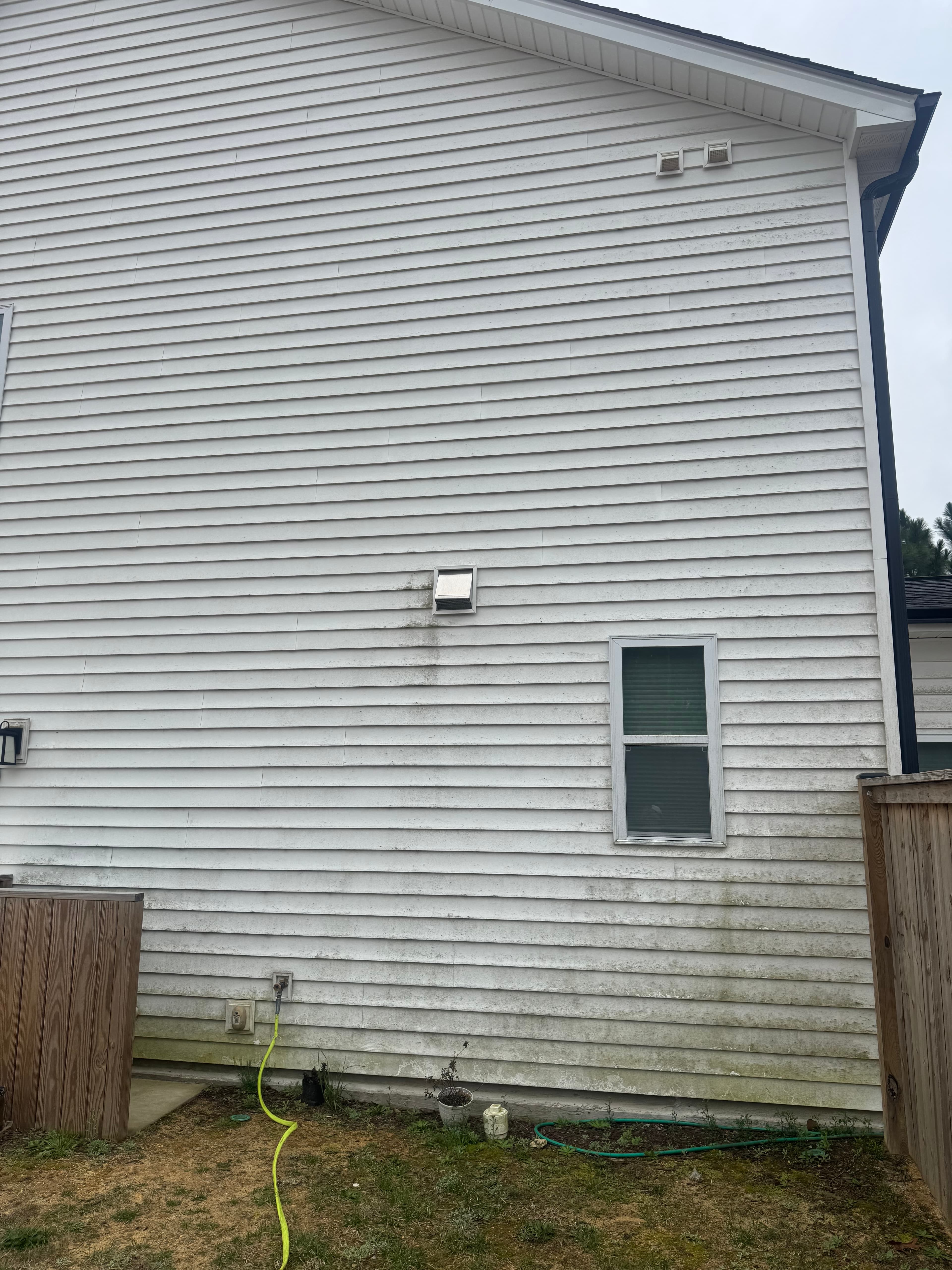 Vinyl surface with heavy algae and discoloration in Fayetteville NC before soft washing