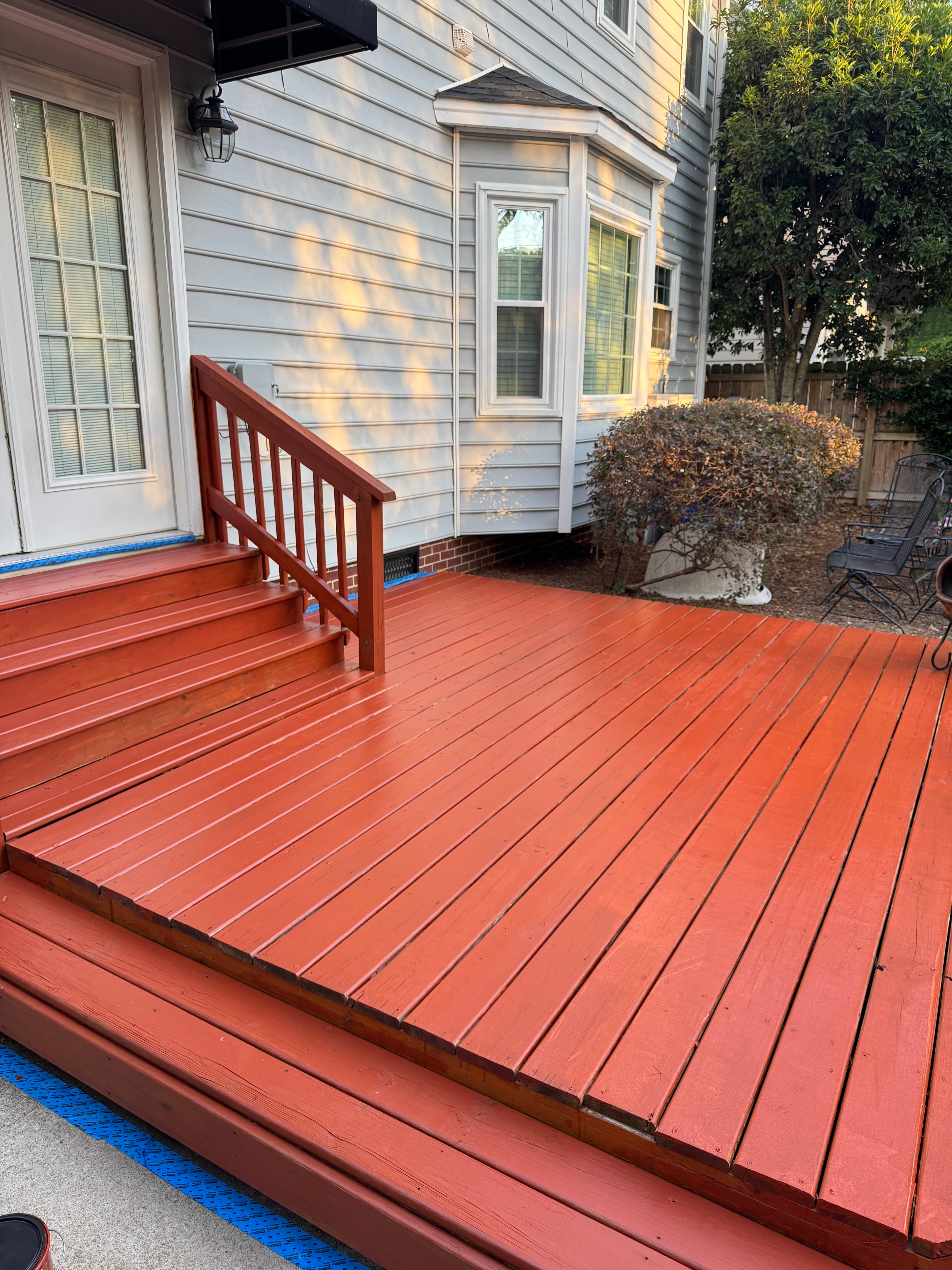 Wood deck with rich red stain applied by Max Pressure in Fayetteville NC